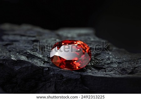 Red Ruby gemstone on stone background, close up shot