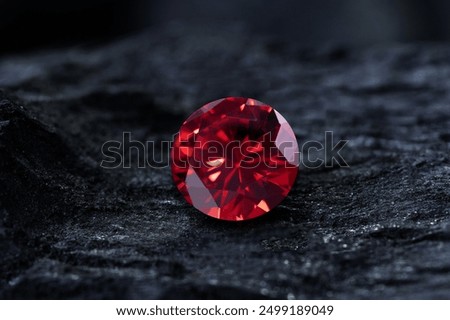 Red Ruby gemstone on stone background, close up shot
