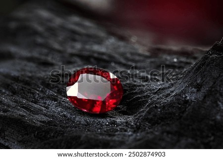 Red Ruby gemstone on stone background, close up shot