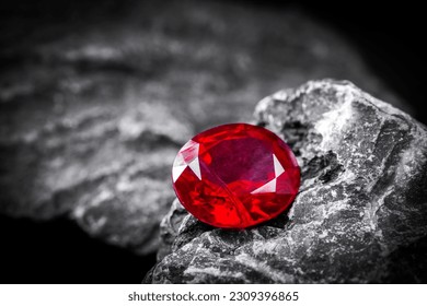 Red Ruby gemstone Round Cut on stone background, close up shot