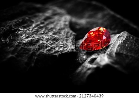 Red Ruby gemstone Round Cut on stone background, close up shot