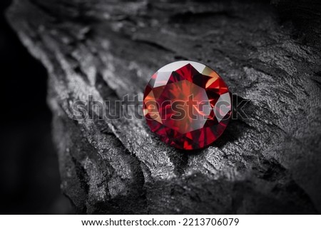 Red Ruby gemstone Round Cut on black coal background