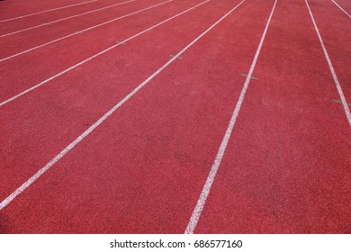 Red running track in stadium. White line