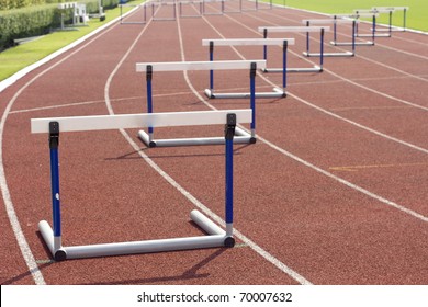 red running tracks with three hurdles set up for training - Shutterstock ID 70007632