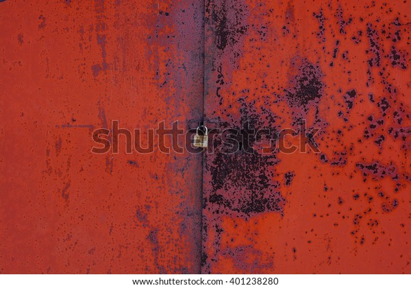 red rusty gate with a\
lock