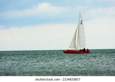 Red Sailboat Sailing In The Sea