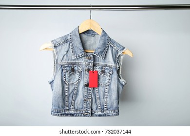 Red Sale Tag With Jeans Jacket On Wooden Hanger