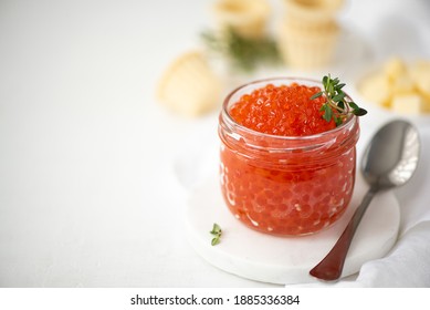 red salmon caviar in a glass jar, close-up