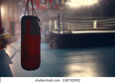 a red sanbag is hanging in front of the boxing ring in a gym for shooting a movie - Powered by Shutterstock