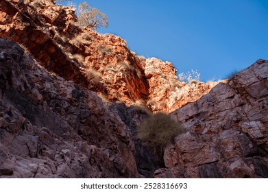 Red sandstone cliffs, Explosion Gorge, El Questro Wilderness Park, Durack, West Australia. Sheer rock face with blue sky background - Powered by Shutterstock