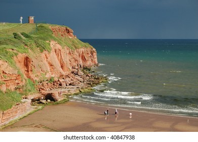 Red sandstone cliffs and a sandy beach in Exmouth, Devon (England)
