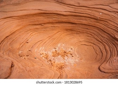 Red Sandstone Eroded In Circular Pattern With Red Sand Particles