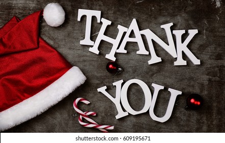 Red Santa Hat And Letters Thank You On A Grey Textured Wooden Background