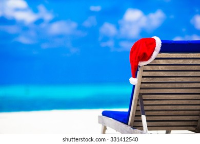 Red Santa Hat On Beach Longue At Tropical Resort