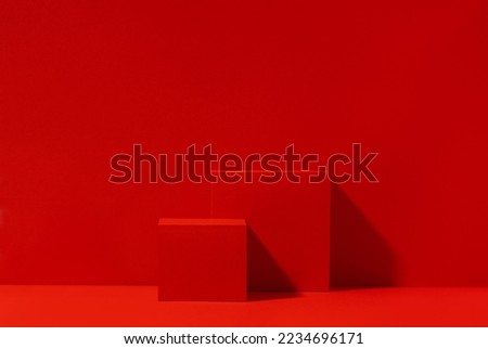 Red scene for product presentation, red podium with copy space. Front view, studio photography.