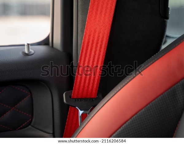 red seat belts in the interior of a sports car\
with a red interior