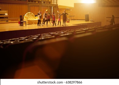 Red Seats In The Auditorium Quietly And Without People . On Stage, A Rehearsal Stage Version.
 