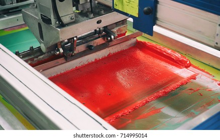 Red section of the screen printing machine, textile roundabout - Shutterstock ID 714995014