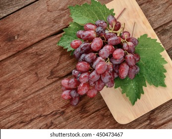 Red Seedless Grapes On A Wooden Table