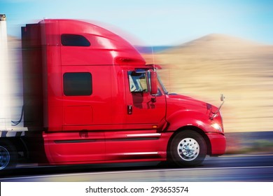 Red Semi Truck On The Road. Semi Truck Tractor Closeup. American Road Transportation.