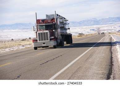 Red semi truck on winter road,   Utah