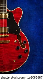 red semi-hollow electric guitar on blue velvet background