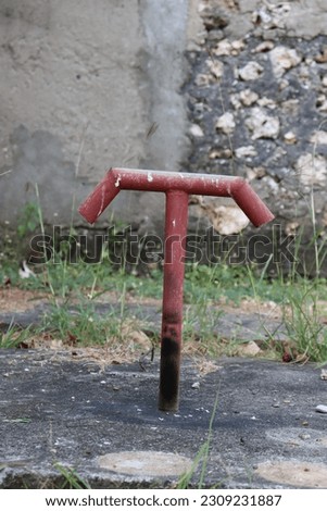 Red septic tank pipe with two holes