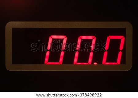 Red seven-segment LED display on electronic weight scale panel showing zero.