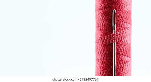 Red Sewing Thread Spool with Needle and Copy Space
