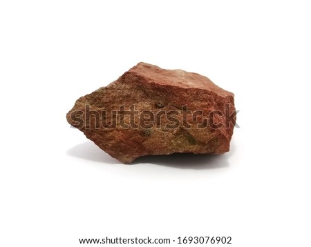 Red shale stone on white background. Shale is a sedimentary rock composed of very fine clay particles.