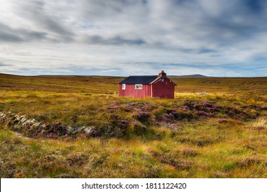A red shieling hut on Pentland Road near Stornoway on the Isle of Lewis in the Outer Hebrides of Scotland