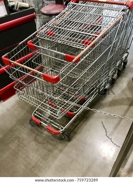 Red shopping cart in the mall. Used to carry\
items easily.
