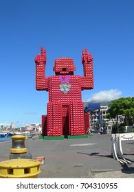 Red Sitting Giant Crate Man Sculpture  At Cape Town , South Africa , Aim To  Draw Attention To The Ever-increasing Importance Of Recycling Both Cans And Plastic Bottles.  Photo Taken In  2012 . 