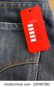 Red Size Tag On Blue Jeans