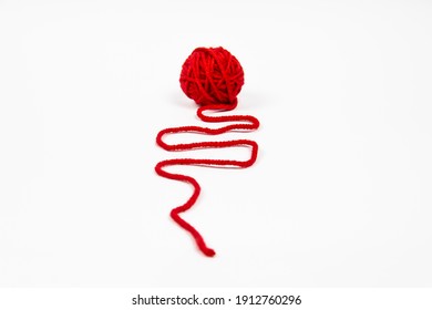 Red skein of thread against white background. Red ball of wool red thread isolated on white