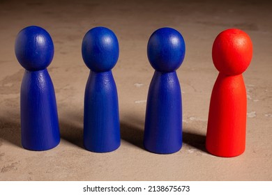 Red Skittle And Three Blues. Teamwork With Outstanding Team Member Or Leader. Dare To Be Different. Standing Out From The Crowd