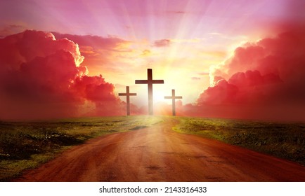 Red  sky at sunset. Beautiful landscape with road   leads up to cross. Religion concept.Christianity background