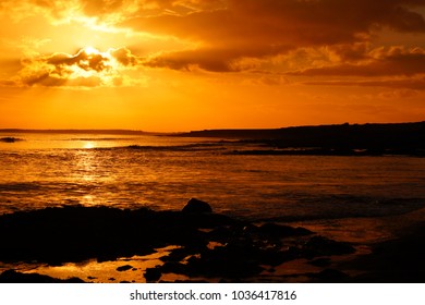 Red Sky Sunset Silhouette Cullenstown Beach in Bannow Wexford Ireland.