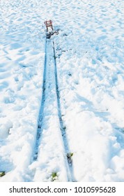 Red Sled At The End Of Track In Snow.