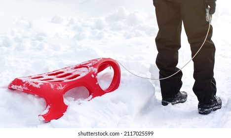 Red Sleigh On The Snow With A Child.