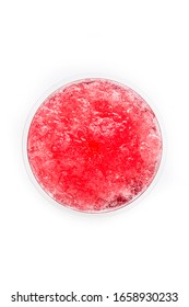 Red slushie in plastic cup isolated on white background. Top view