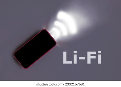 Red Smartphone on a gray studio background with light Emitting data. Li-Fi wireless communication concept. Light-Fidelity. W-Lan technology, internet and networking. High speed connection. Wi-Fi sign.