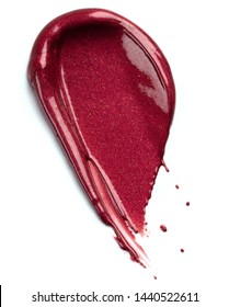Red smear of lipgloss on white background. Creamy texture of rich red lipgloss.