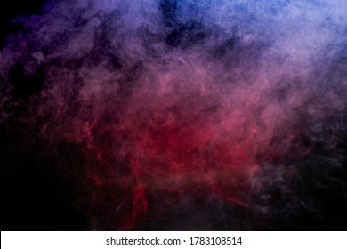 Red Smoke And Blue Smoke Against A Black Background