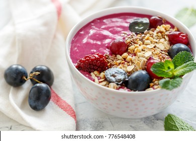 Red Smoothie Bowl With Beets, Granola, Flax Seeds And Black Grapes For Tasty And Healthy Breakfast, Selective Focus.