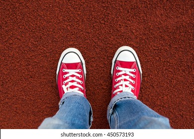 Red Sneaker On Running Track . Top View