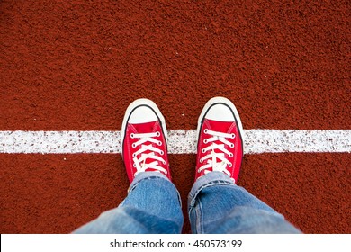 Red Sneaker On Running Track . Top View