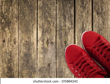 red sneakers in the right side on wooden deck  - Powered by Shutterstock