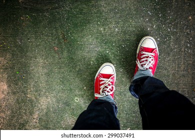 Red Sneakers Shoes Walking On Concrete Look Top View , Canvas Shoes On Dirty Concrete , Hister Life