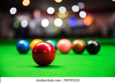 Red snooker ball on snooker table